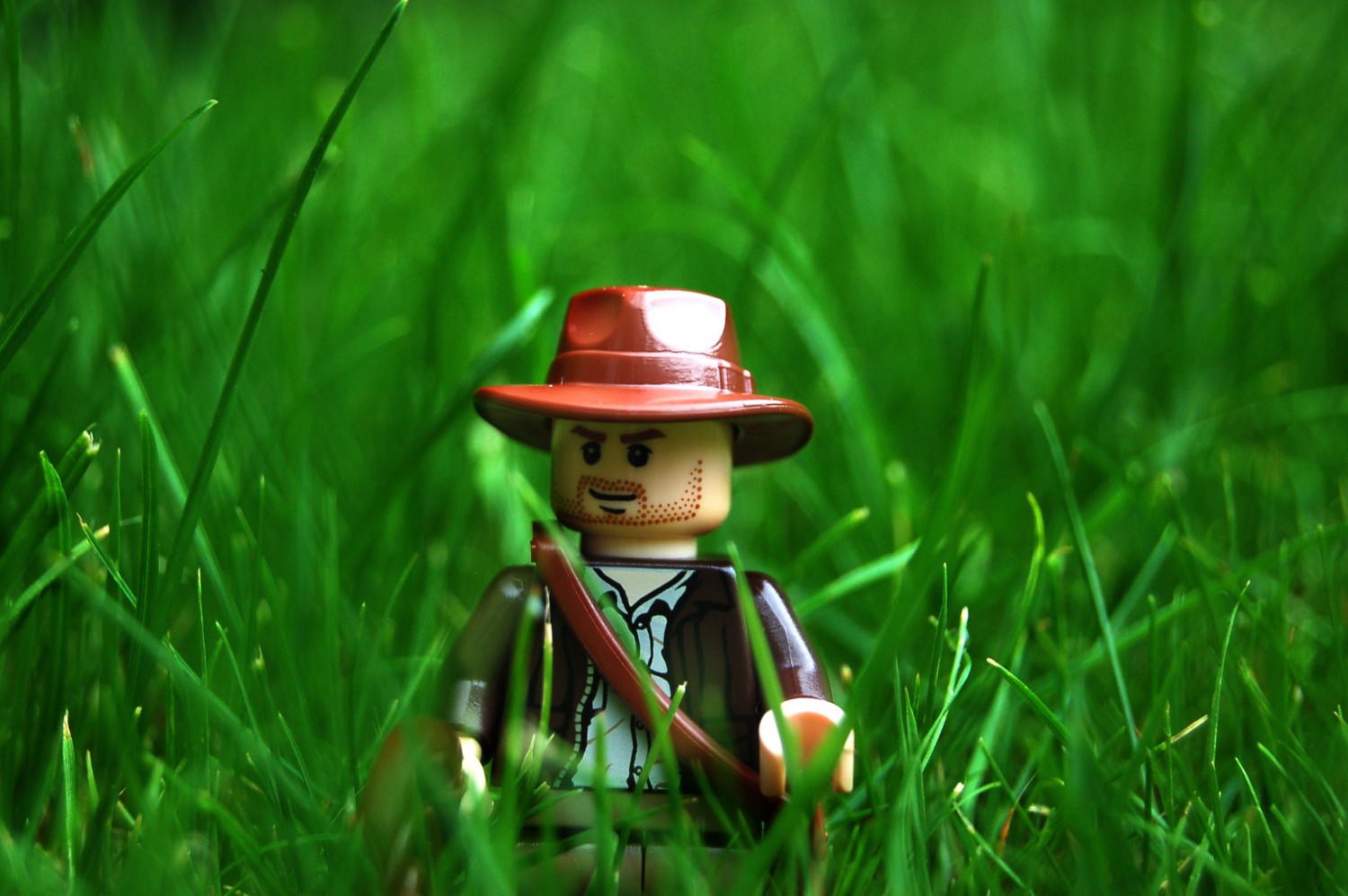 a Lego Idiana Jones in the grass